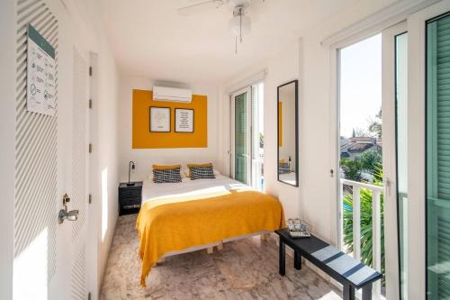 a bedroom with a bed and a large window at Charming 10 pers Villa with swimmingpool Sevilla in Tomares