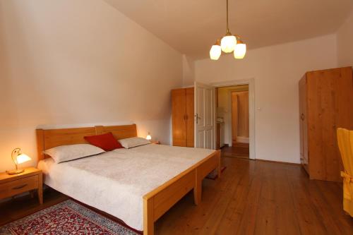 a bedroom with a large bed in a room at Penzion Jelen Vranov nad Dyjí in Vranov nad Dyjí