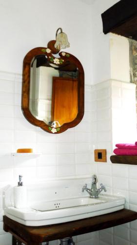 a bathroom with a sink and a mirror at Casa del Conde - Ajanedo in Ajanedo
