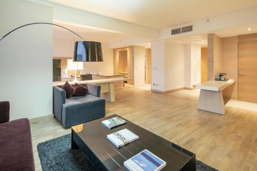 a living room with a couch and a table at Wyndham Concepcion Pettra in Concepción
