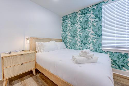 a bedroom with a bed with a teddy bear on it at Caribbean Sea Studio Apartment in Galveston