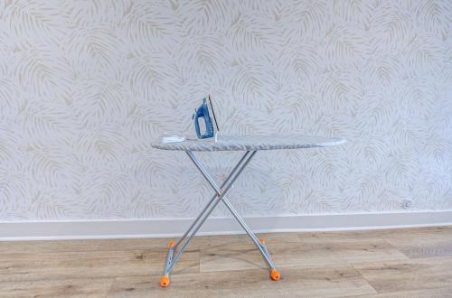 a table with a pair of scissors on it in front of a wall at Caribbean Sea Studio Apartment in Galveston