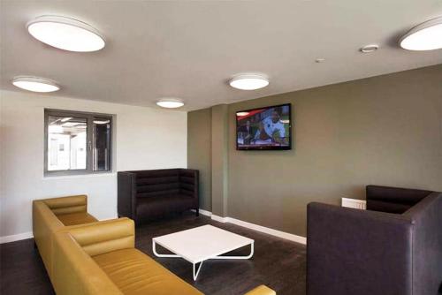 a waiting room with two couches and a tv at Edinburgh College Residence in Edinburgh