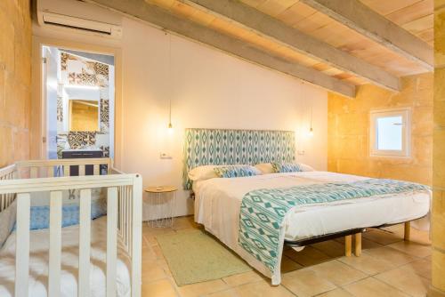 a bedroom with a large bed and a staircase at Sant llorens - 4341-21 Mallorca in Sant Llorenç des Cardassar