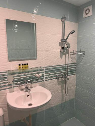 a bathroom with a sink and a shower at Хотел Диамант Hotel Diamond in Balchik