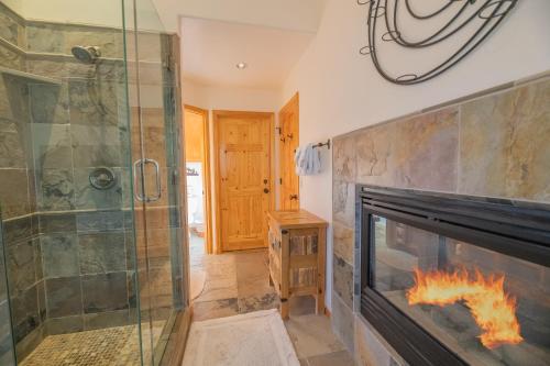 a bathroom with a fireplace and a walk in shower and a glass shower at Bearfoot Bungalow - Premium and spacious home close to the National Forest and The Village! in Big Bear Lake
