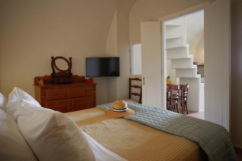 a room with a bed with a hat on it at Arvanitis Cave Village in Akrotiri