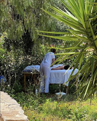 a person laying on a bed in a field at La Maison One B&B in Carovigno