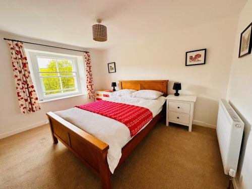 a bedroom with a large bed and a window at Apple Tree Cottage in Marske