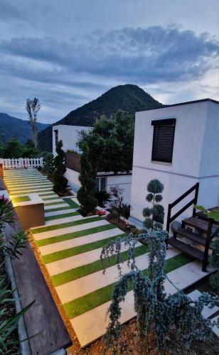 a building with a bunch of stairs in front of it at Koman Paradise by Romina in Shkodër