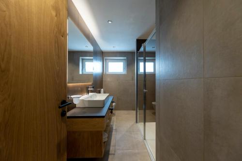 a bathroom with a sink and a shower at Hotel Lido - slow & natural living in Molveno