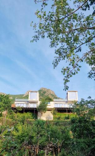 a building on top of a hill with trees at Koman Paradise by Romina in Shkodër