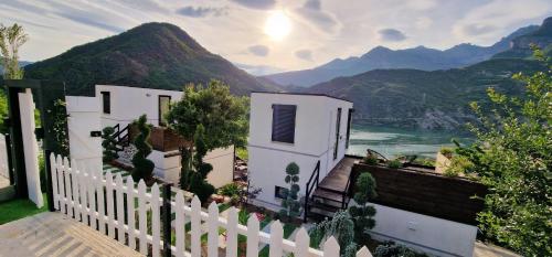 a white fence with a view of the mountains at Koman Paradise by Romina in Shkodër