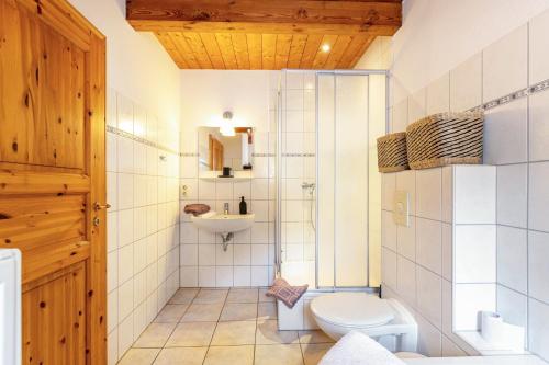 a bathroom with a toilet and a sink at Ferienhaus Landleben und Meer in Tetenbüll