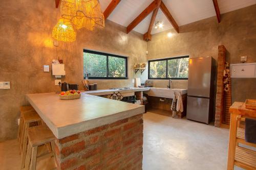 a large kitchen with a sink and a refrigerator at Ibhubesi house in Marloth Park