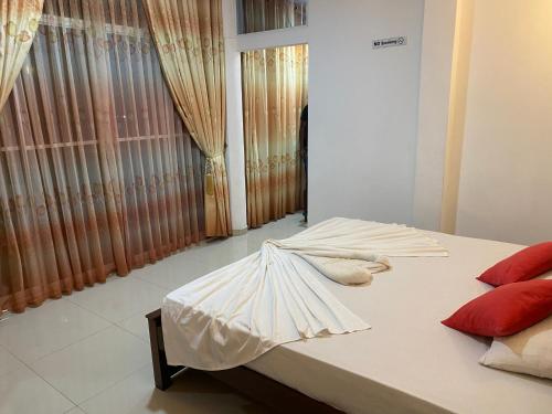 a bedroom with a bed with an umbrella on it at Nesh Villa in Aluthgama