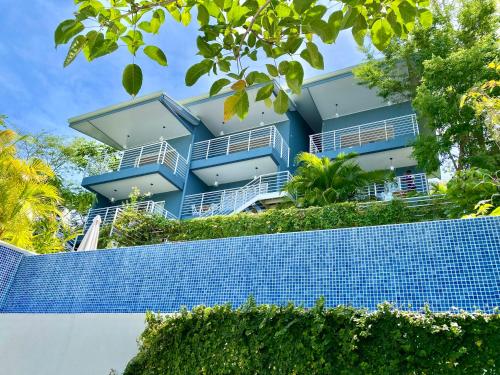 a blue building on top of a blue tile wall at Altamar in Santa Teresa Beach
