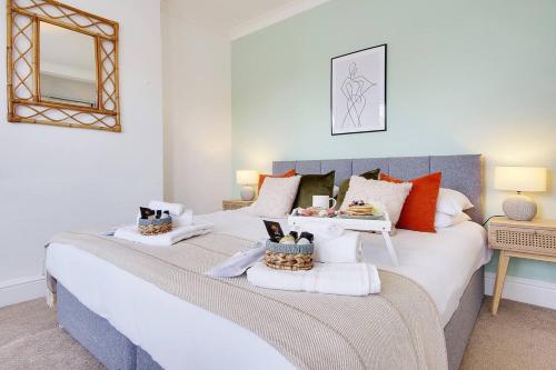 a bedroom with a large bed with two baskets on it at SeaEsta Stays -Game Room&VR &EV point in Bournemouth