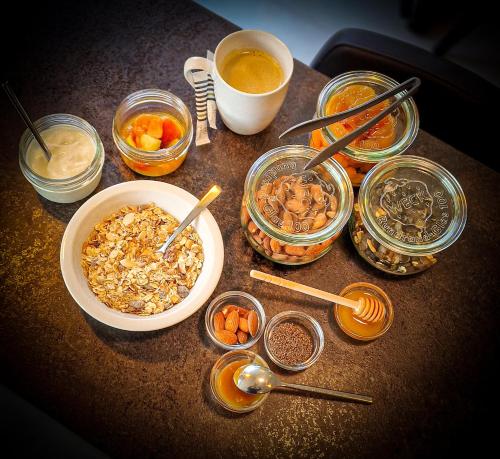 a table topped with bowls of food and other ingredients at Quality Hotel La Marebaudière Vannes Centre in Vannes