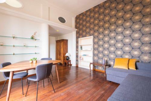 a dining room with a table and a couch at Colosseum Loft - ZENO 12 in Rome