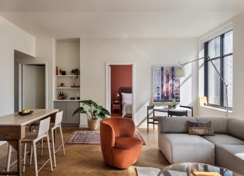 a living room with a couch and a table at ROOST Detroit in Detroit