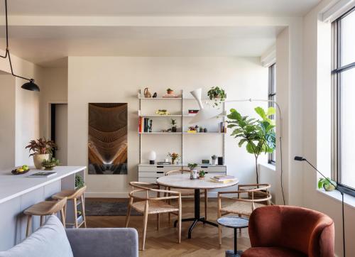 a living room with a table and chairs at ROOST Detroit in Detroit
