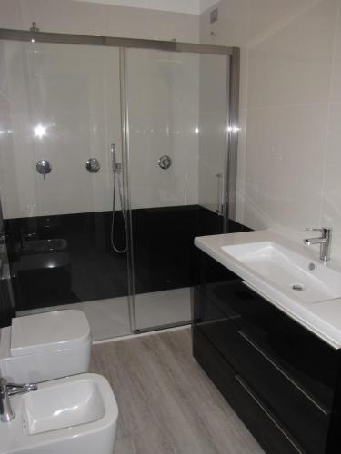 een badkamer met een douche, een toilet en een wastafel bij Homely Rapallo in Rapallo