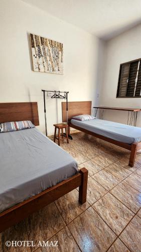 Una cama o camas en una habitación de HOTEL AMAZ