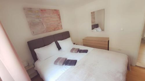 a bedroom with a white bed with two pillows at Two bedroom apartment Bambi in Vir