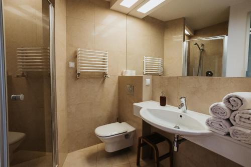 a bathroom with a sink and a toilet and a shower at Plac Nowy - Beautiful view of the Old Town in Krakow