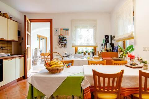 a kitchen with a table with a basket of bananas on it at Rooms Leban in Šempas