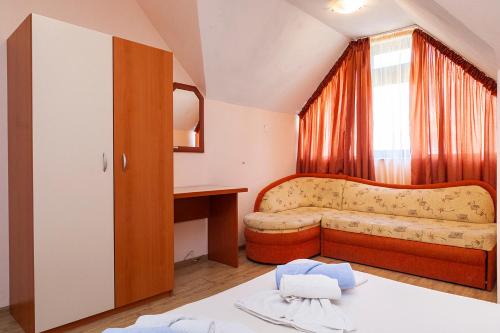 a living room with a couch and a window at Ravda Bay Guest House in Ravda