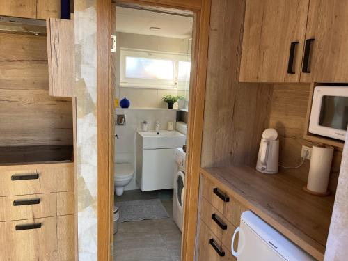 a small bathroom with a toilet and a sink at kotedza Tīkli 2 in Bigauņciems