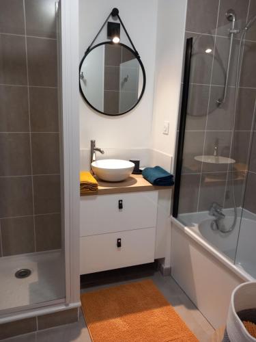 a bathroom with a sink and a shower at le loft de la riviéra in Bénodet