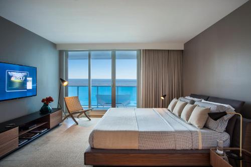a bedroom with a large bed with a view of the ocean at Incredible Ocean Views! Terrace, 1800 sq.ft., Hotel in Miami Beach