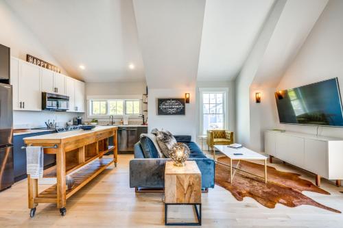 a living room with a blue couch and a kitchen at 14 Mi to Dtwn Denver Sleek Westminster Home in Westminster