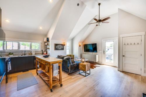 a kitchen and living room with a ceiling fan at 14 Mi to Dtwn Denver Sleek Westminster Home in Westminster