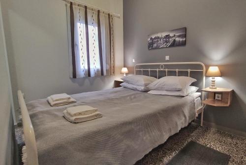 a bedroom with a bed with two towels on it at GARNET 3 in Kalamata