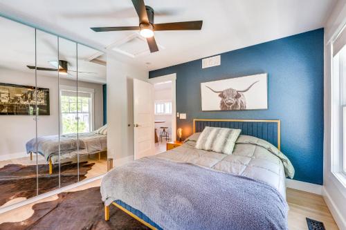 a bedroom with a bed and a blue wall at Westminster Vacation Rental about 15 Mi From Denver in Westminster