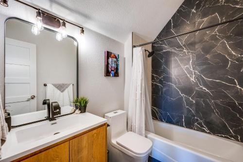 a bathroom with a sink and a toilet and a tub at Westminster Vacation Rental about 15 Mi From Denver in Westminster