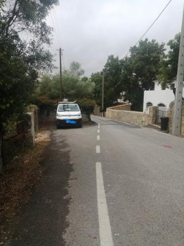 a white car parked on the side of a road at ADEGA Residências Artísticas - Perto de Lisboa in Almargem