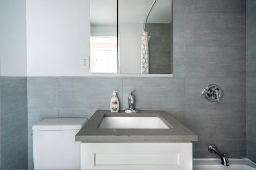 a bathroom with a sink and a mirror at Apartment in Columbus Avenue in New York