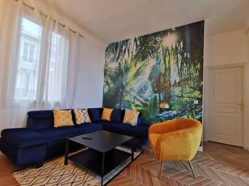 un salon avec un canapé bleu et un tableau dans l'établissement Vista Monaco, 5mn walk to Monaco, Amazing view, à Beausoleil