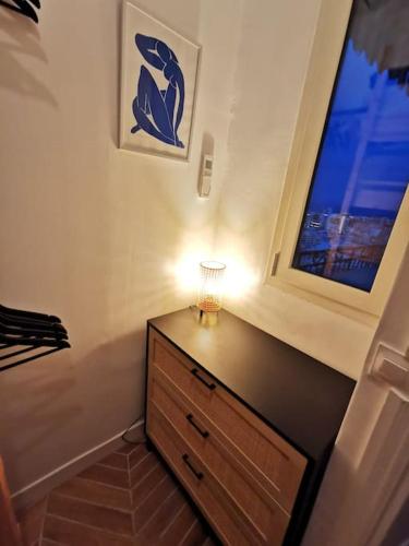 a bedroom with a dresser with a window and a lamp at Vista Monaco, 5mn walk to Monaco, Amazing view in Beausoleil
