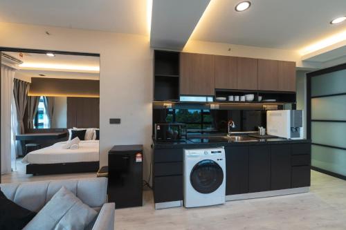 a kitchen with a washing machine in a room at Bornean Milieu @ JQ Kota Kinabalu in Kota Kinabalu