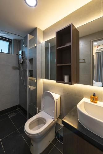 a bathroom with a toilet and a sink and a shower at Bornean Milieu @ JQ Kota Kinabalu in Kota Kinabalu