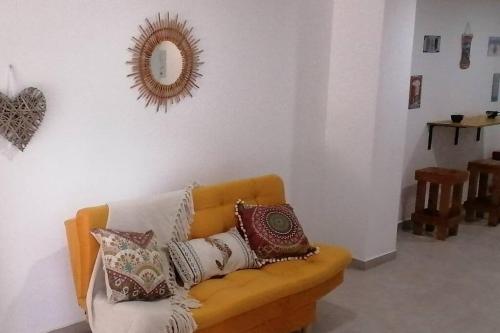 a living room with a couch with pillows on it at Nativo House amplio y acogedo in Medellín