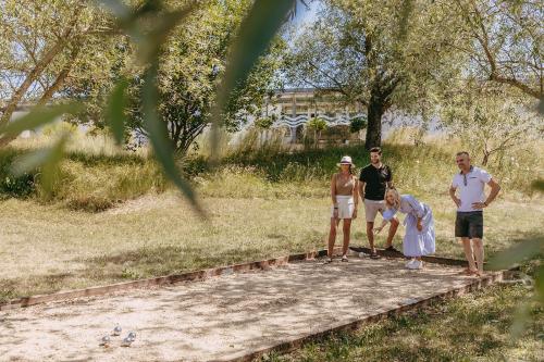a group of people standing around in a park at Hotel Palafitte in Neuchâtel