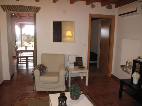 a living room with a chair and a table at Casa do Castelo - Muralha in Castelo de Vide
