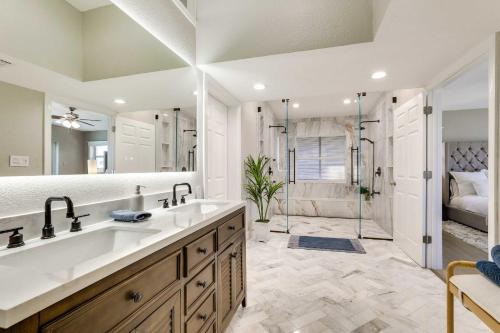 a bathroom with a large sink and a shower at Luxury St Petersburg Home with Pool and Bay Access! in St Pete Beach